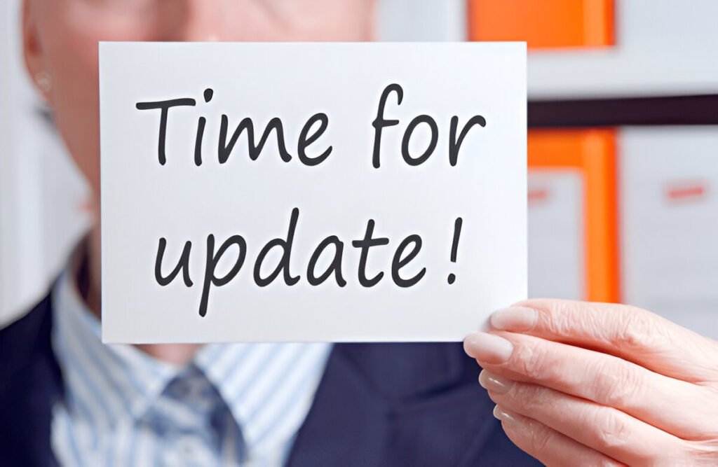 Person holding a sign that says Time for update
